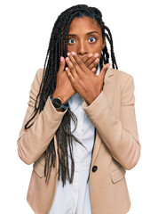 Wall Mural - African american woman wearing business jacket shocked covering mouth with hands for mistake. secret concept.