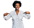 African american woman with afro hair pointing with fingers to herself winking looking at the camera with sexy expression, cheerful and happy face.