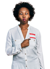 Canvas Print - African american woman with afro hair wearing hello my name is sticker identification making fish face with mouth and squinting eyes, crazy and comical.