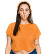 Leinwandbild Motiv Young hispanic woman wearing casual clothes making fish face with lips, crazy and comical gesture. funny expression.