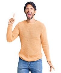 Poster - Handsome hispanic man wearing casual sweater pointing finger up with successful idea. exited and happy. number one.