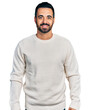 © Krakenimages.com - Young hispanic man with beard wearing casual white sweater with a happy and cool smile on face. lucky person.