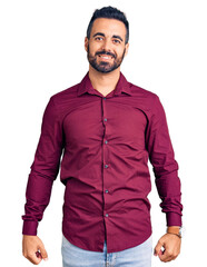 Sticker - Young hispanic man wearing casual clothes looking positive and happy standing and smiling with a confident smile showing teeth