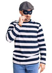 Sticker - Young handsome man wearing burglar mask mouth and lips shut as zip with fingers. secret and silent, taboo talking