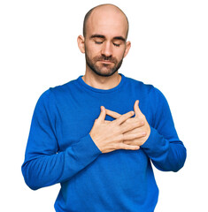 Canvas Print - Young hispanic man wearing casual clothes smiling with hands on chest with closed eyes and grateful gesture on face. health concept.