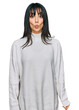 © Krakenimages.com - Young brunette woman with bangs wearing casual turtleneck sweater making fish face with lips, crazy and comical gesture. funny expression.