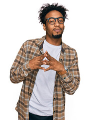 Sticker - Young african american man with beard wearing casual clothes and glasses hands together and fingers crossed smiling relaxed and cheerful. success and optimistic