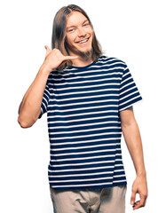 Poster - Handsome caucasian man with long hair wearing casual striped t-shirt smiling doing phone gesture with hand and fingers like talking on the telephone. communicating concepts.