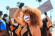 © ADDICTIVE STOCK - Woman protesting in mask with black lives matter inscription