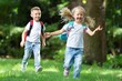 © BillionPhotos.com - Little kids schoolchildren pupils running in park from school.