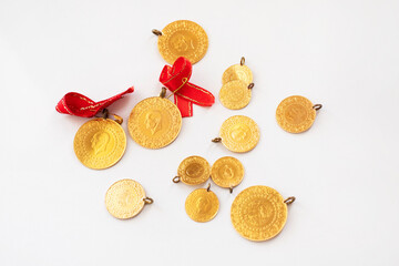 Turkish gold coins with ribbon on white background.