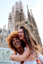 Vertical Photo Of A Lovely Multiehtnic Tourists Couple In Barcelona, Spain During Summer Season