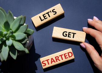 Wall Mural - lets get started symbol. concept words lets get started on wooden blocks. beautiful deep blue backgr