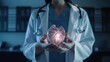 Female doctor holding in hands medical model anatomic organ – heart.