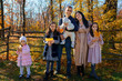 © soleg - a big family posing together in an autumn city park, children and parents, happy people enjoying beautiful nature, a bright sunny day and yellow leaves