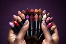 A Hand Holding A Selection Of Colorful, High - End Lipstick Bullets In An Array Of Shades From Nude To Deep Burgundy, Matte And Shiny Textures, Natural Daylight, Shallow Depth Of Field