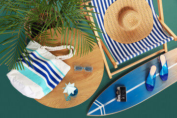 Wall Mural - Deckchair, beach accessories and palm tree on color background