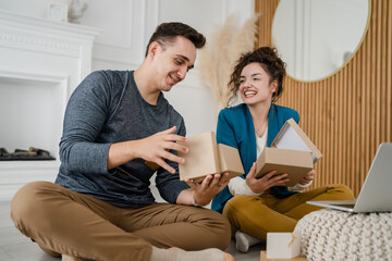 man and woman couple give open gift box presents at home happy smile