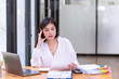 © nuwatphoto - Asian businesswoman stressed with work in front of a laptop in the office.