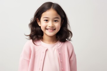 portrait of a cute asian little girl smiling over white background