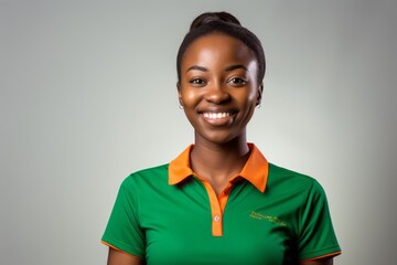 Wall Mural - Young african american football fan woman smiling isolated on grey background