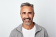 © Anne Schaum - Portrait of handsome mature man looking at camera and smiling while standing against white background