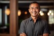 © Eber Braun - Portrait of a handsome asian man smiling at the camera.
