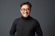 © Anne Schaum - Portrait of a smiling asian man in black sweater and glasses