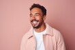 © Leon Waltz - Portrait of a handsome young man smiling while standing against pink background