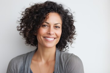 Wall Mural - Close-up portrait photography of a satisfied Brazilian woman in her 30s wearing a chic cardigan against a white background 