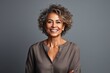 © Robert MEYNER - Portrait of beautiful middle aged woman with curly hair smiling at camera
