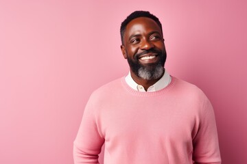 Wall Mural - Portrait of a smiling african american man on pink background