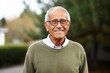 © Robert MEYNER - Medium shot portrait photography of a happy Brazilian man in his 70s wearing a chic cardigan against a white background
