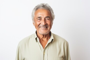 Lifestyle portrait photography of a pleased Brazilian man in his 70s wearing a chic cardigan against a white background 