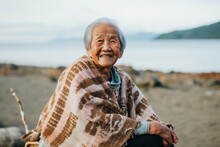 Portrait Of An Elderly Asian Woman Sitting On The Beach And Smiling