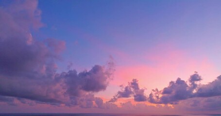 Wall Mural - aerial view beautiful purple cloud in pink sky at horizon above the sea..Clouds obscured the pink sky in the evening background for creative nature .and travel concept. sky texture.