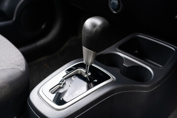 automatic transmission shift selector in the car interior. Closeup a manual shift of modern car gear shifter. 4x4 gear shift