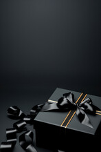 Black Gift Box On Black Background With Empty Space For Text.