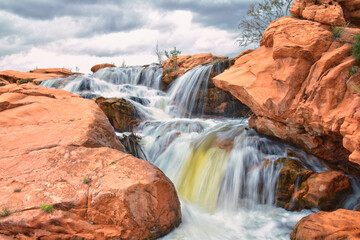 Wall Mural - Gunlock Falls State Park Reservoir waterfall views, Utah by St George. 2023 record snowpack spring run off over desert erosion sandstone. Utah, USA.