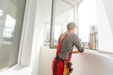 Wall Mural - The foreman installs a window frame in the room