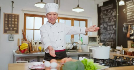 Wall Mural - Asian elderly chef in kitchen