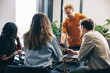 © Jacob Lund - Multicultural group of professionals engaging in a business meeting