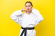 © luismolinero - Young caucasian woman doing karate isolated on yellow background having doubts and thinking