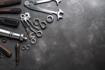 Auto mechanic's tools on grey stone table with copy space