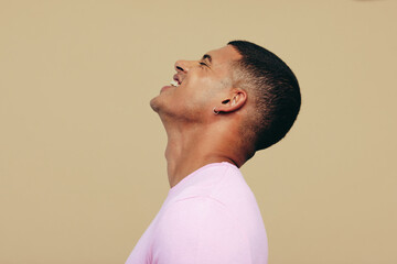 Wall Mural - Young man smiling as he shows his beautiful radiant skin in a studio