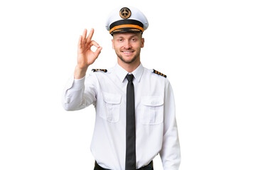 Wall Mural - Airplane pilot man over isolated background showing ok sign with fingers