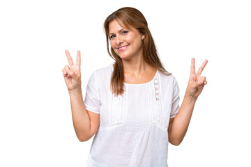 Canvas Print - Middle-aged caucasian woman over isolated background showing victory sign with both hands