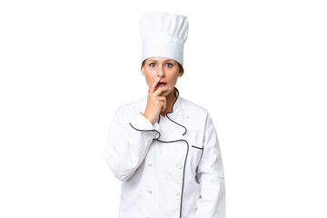 Wall Mural - Middle-aged chef woman over isolated background surprised and shocked while looking right