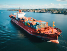 Immerse Yourself In The Panoramic Perspective Of An Aerial View, Where A Container Cargo Ship Traverses The Open Sea, Symbolizing The Interconnectedness Of Global Commerce. 