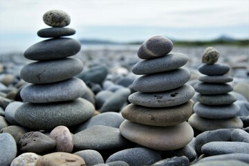 three zen towers on a stony beach. towers made of pebbles.